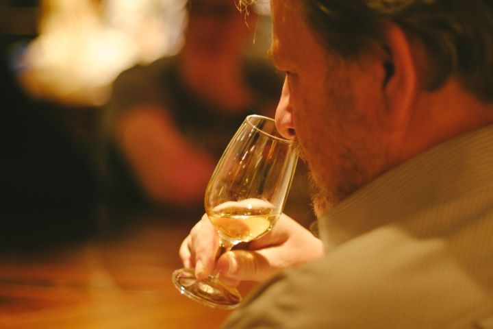 Whisky enthusiast examining the colour and aroma of a rare single cask whisky.