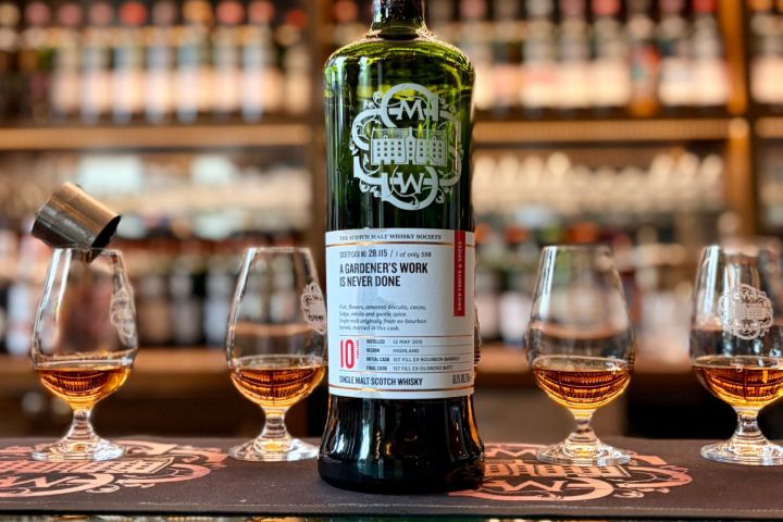 A rare cask-strength Single Cask Scotch whisky bottle displayed with four Glencairn tasting glasses.